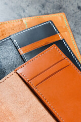 Black leather cardholder on a gray background. Handmade leather products.