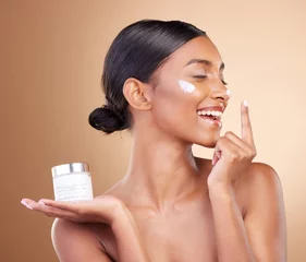 Foto auf Acrylglas Schönheitssalon Woman, face and smile with moisturizer cream for beauty skincare cosmetics, self love or care against a studio background. Happy female smiling for lotion, moisturizing creme or facial treatment