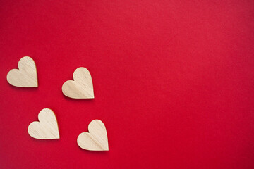 Four wooden hearts placed on viva magenta background. Top view. Flat lay copy space.