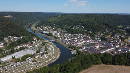 Fototapeta premium Aerial drone view of the small German village called Bad Karlshafen. Old white European buildings in a touristy town on the river Wezer.