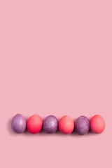 Easter card with colorful eggs on a pink background