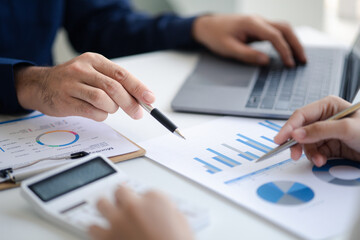 Group business people are brainstorming together and reviewing the company financial documents that the finance department has summarized, they are business partners. Business administration concept.