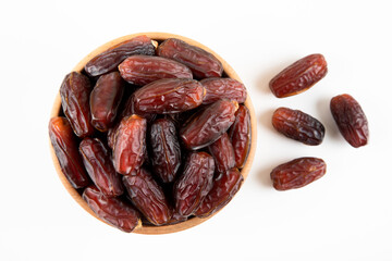 Date fruits in wooden bowl,on white background,top view