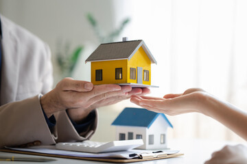 Real estate agents explain models of housing estates in projects to elaborate to clients,...