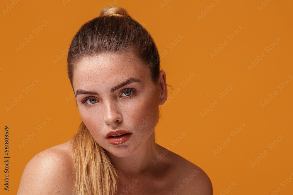 Wall mural Natural, young woman with a lot of freckles on her face and shoulder. Beauty portrait