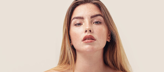 Studio beauty portrait of young natural woman with freckles on her face. Ideal, delicate makeup...