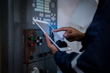 Engineer technician under control digital factory production technology by tablet showing automation manufacturing machine process of the new industrial revolution and IOT software to control concept.
