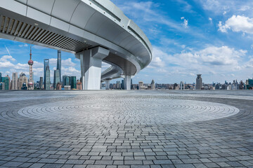 City square and pedestrian bridge with skyline in Shanghai, China.