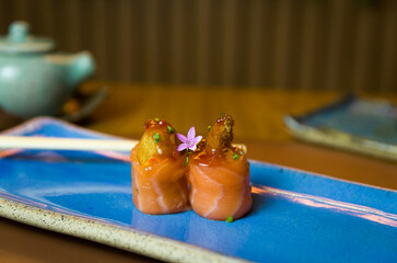 Differents japanese sushi on a elegant blue plate.