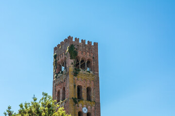 Bell tower of Santi Quirico e Giulitta is 12th-century Roman Catholic parish church in Capannori, province of Lucca, region of Tuscany, Italy. - obrazy, fototapety, plakaty