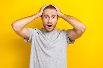Photo of anxious embarrassed man wear grey clothes impressed bad news information isolated on yellow color background - obrazy, fototapety, plakaty