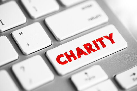 Charity - an organization set up to provide help and raise money for those in need, text concept button on keyboard