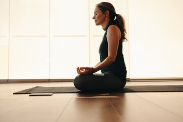 Mature woman doing a breathing exercise during yoga