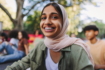 Cheerful Muslim girl smiling at the camera at a protest
