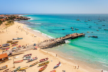 Pier and boats on turquoise water in city of Santa Maria, Sal, Cape Verde
