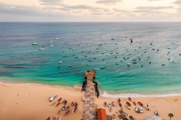 Pier and boats on turquoise water in city of Santa Maria, Sal, Cape Verde
