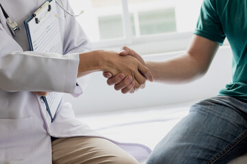 Doctor shaking hands with patient at clinic or hospital. Medical.