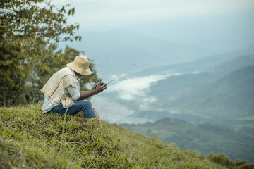 afro farmer man listening to radio
