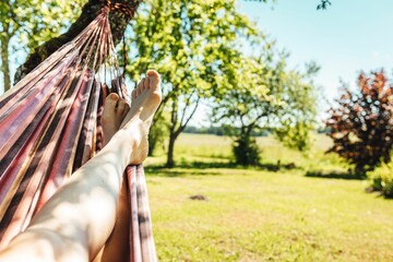 Man relaxing in the hammock on a sunny day