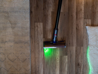 Vacuumed with a modern vacuum cleaner. Cleaning of the apartment. Close-up.