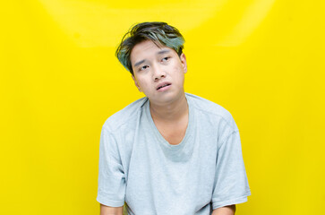 portrait of An Asian man has a stressed, glum, and messed-up appearance. a man who is angry and agitated. freaked out over work.