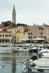 Historic cityscape of Croatian Mediterranean sea coast - old town Rovinj and boats on water of Istria Croatia