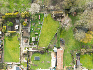 Drone view of many chicken sheds and runs seen together with a small fruit orchard towards the top of the image. © Nick Beer