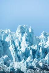Foto auf Acrylglas Vertical shot of icy glaciers and wild nature in Alaska in blue sky background © Tomáš Malík/Wirestock Creators