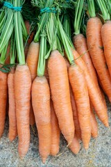 Vertical closeup of a pile of carrots