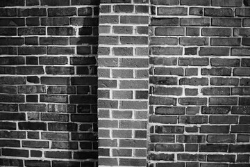 A minimalist view ofa brick wall in black and white.