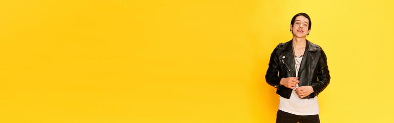 Banner with joyful young guy smiling at camera over yellow background. Copy space for ad, text