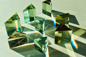Aesthetic of dispersion of light, clear triangular glass prism placed different angles splitting...