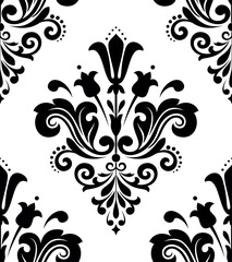 Obraz premium Wallpaper in the style of Baroque. Seamless vector background. White and black floral ornament. Graphic pattern for fabric, wallpaper, packaging. Ornate Damask flower ornament