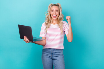 Photo of overjoyed positive lady wear trendy striped clothes raise fist yes hooray pass online exam isolated on cyan color background