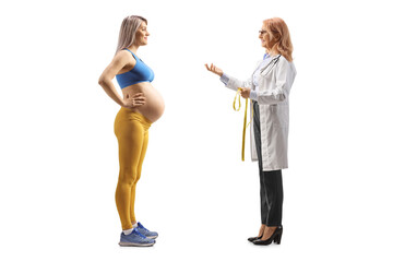 Female doctor talking to a pregnant woman in sportswear