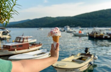 Hand holding two ice cream cones