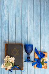 Pesah Jewish Passover holiday celebration concept. Matzah, wineglass, blooming jasmine, and...
