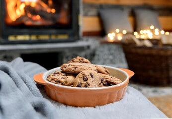 Chocolate chip cookies with Christmas decorations in the background.