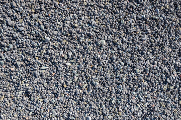 Full-screen texture of fine gray sea pebbles
