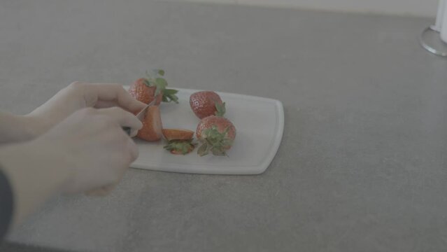 female hands cutting strawberries. shot in slog 3
