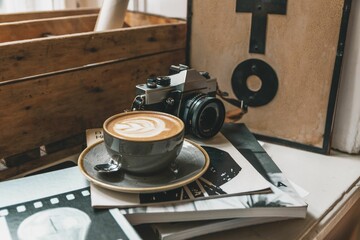 Closeup of a cup of latte with an art pattern on a table in a photo studio