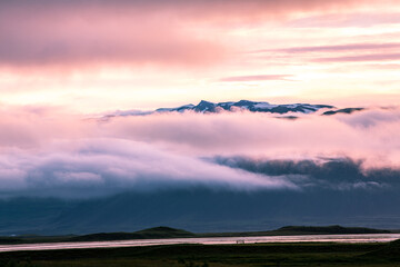 Sunset in Iceland, Mountains and fog in colorful sunset, magic evening, East Iceland, Travel in Iceland