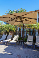 Poolside umbrellas and deck chair.