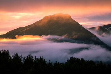 Sunset in Iceland, Mountains and fog in colorful sunset, magic evening, East Iceland, Travel in Iceland
