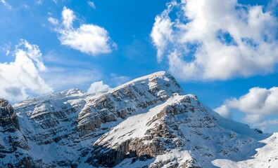 Fototapeta na wymiar Snowy peak of the Mala mojstrovka mountain in the Julian alps in Slovenia against the blue sky