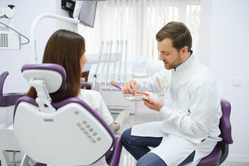 Young smiling woman with beautifiul teeth, having a dental inspection