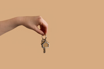 Keys in hand on a yellow background.