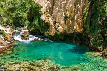 Beautiful creek and turquoise natural pool under rocky cliff at Krcic waterfall near Knin, Croatia