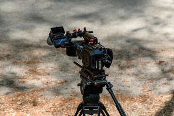 Professional live tv broadcast camera on tripod outdoor by a road