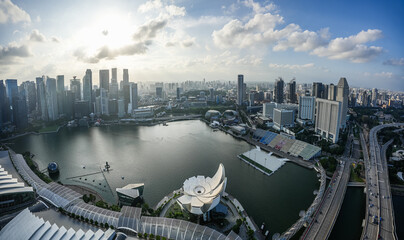 Fototapeta na wymiar Singapore from above. Wide angle panoramic view of the futuristic skyscraper modern buildings skyline from Marina Bay during a beautiful day. Singapore, 2023.